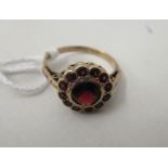 A yellow metal cluster ring, set with garnets