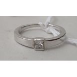 A white gold single stone, rubover set diamond ring