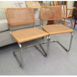 A pair of modern chromium plated, framed chairs with caned backs and seats  stamped Made in Italy