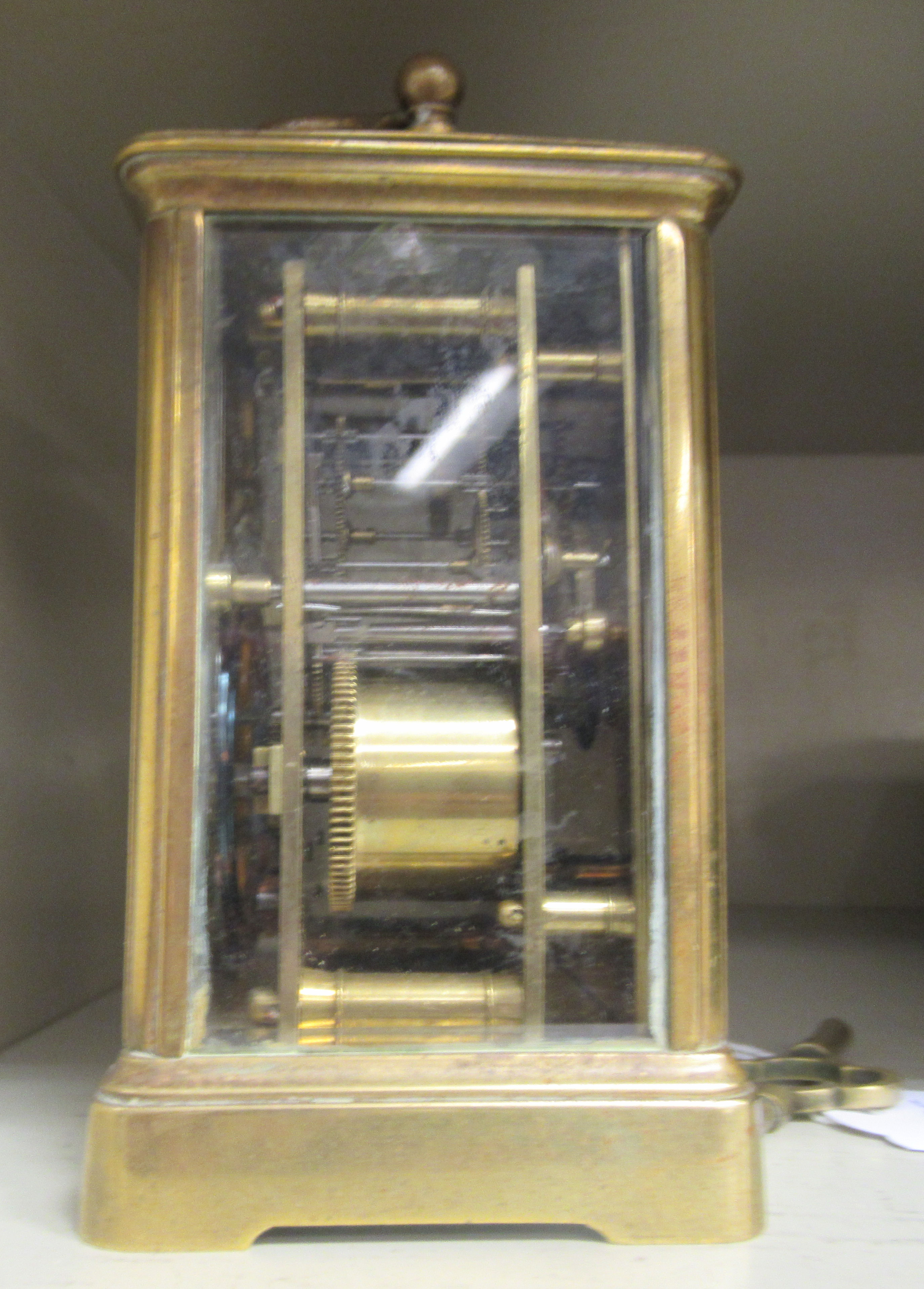 An early 20thC lacquered brass cased carriage clock with bevelled glass panels and a folding top - Image 2 of 3