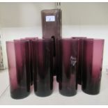 A tinted purple glass cordial jug; and a matching set of ten glasses