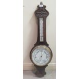 An early 20thC oak aneroid barometer with a thermometer and porcelain dial  30"h