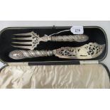 A late Victorian silver fish slice and fork with a decoratively engraved blade and times, on wrythen