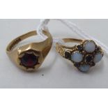 A 9ct gold garnet gypsy design ring; and a yellow metal cluster ring