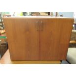 A 1970s teak record cabinet with a pair of doors, on a plinth  19"h  26"w