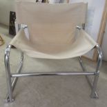 A modern chair, the chromium plated tubular steel frame with a cream coloured canvas sling back