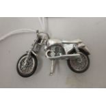 A silver coloured metal miniature model, an early scrambler motorcycle