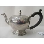 A bachelors silver bullet shaped teapot, having an S-shaped spout, insulated handle and a flush