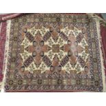 A Caucasian rug, decorated with repeating stylised designs, on a multi-coloured ground  40" x 47"
