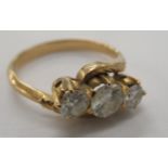 A gold coloured metal, claw set, three stone diamond ring