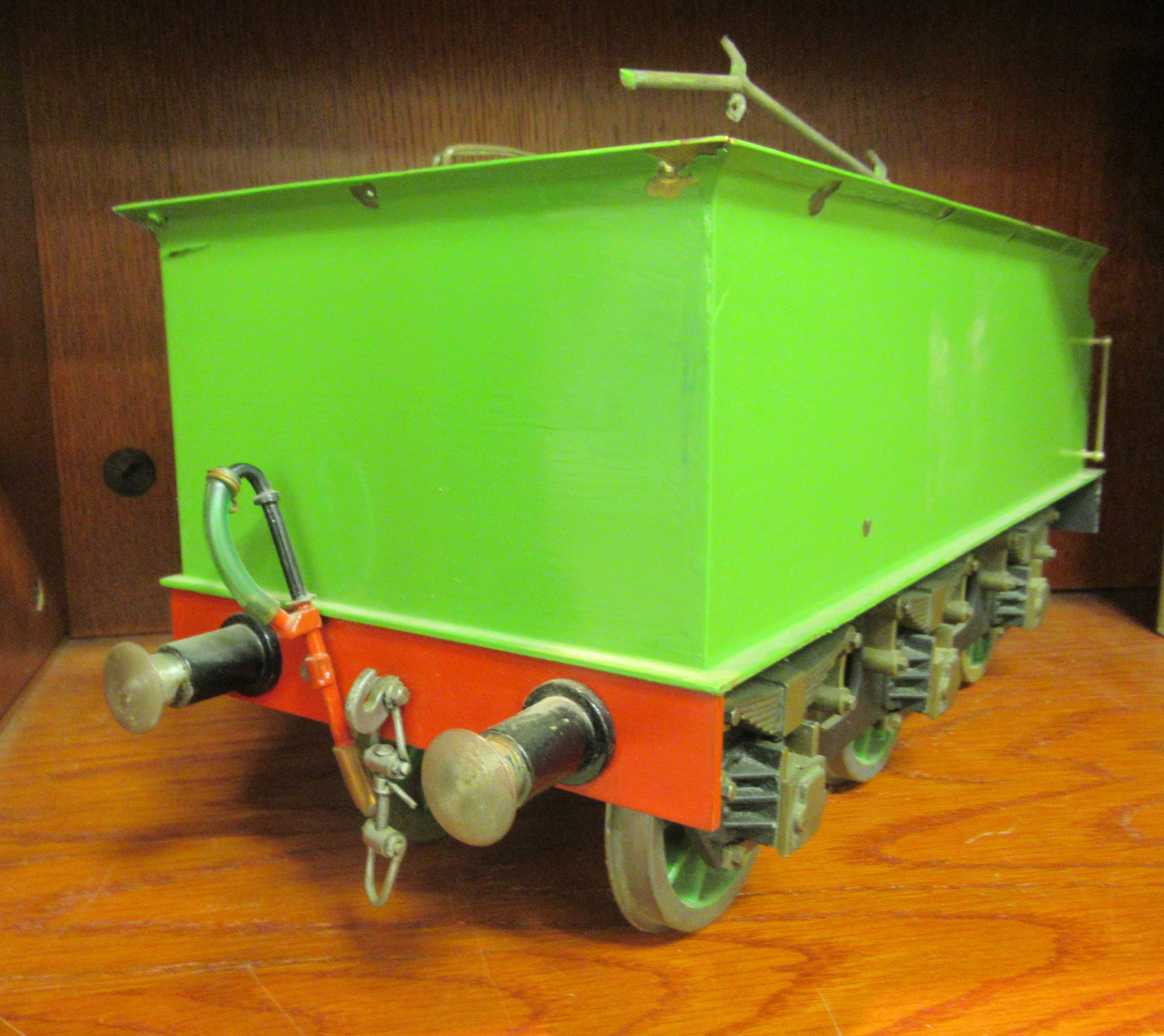 A 3.25" (approx.) gauge six wheel model railway tender, in black and green livery  16"L