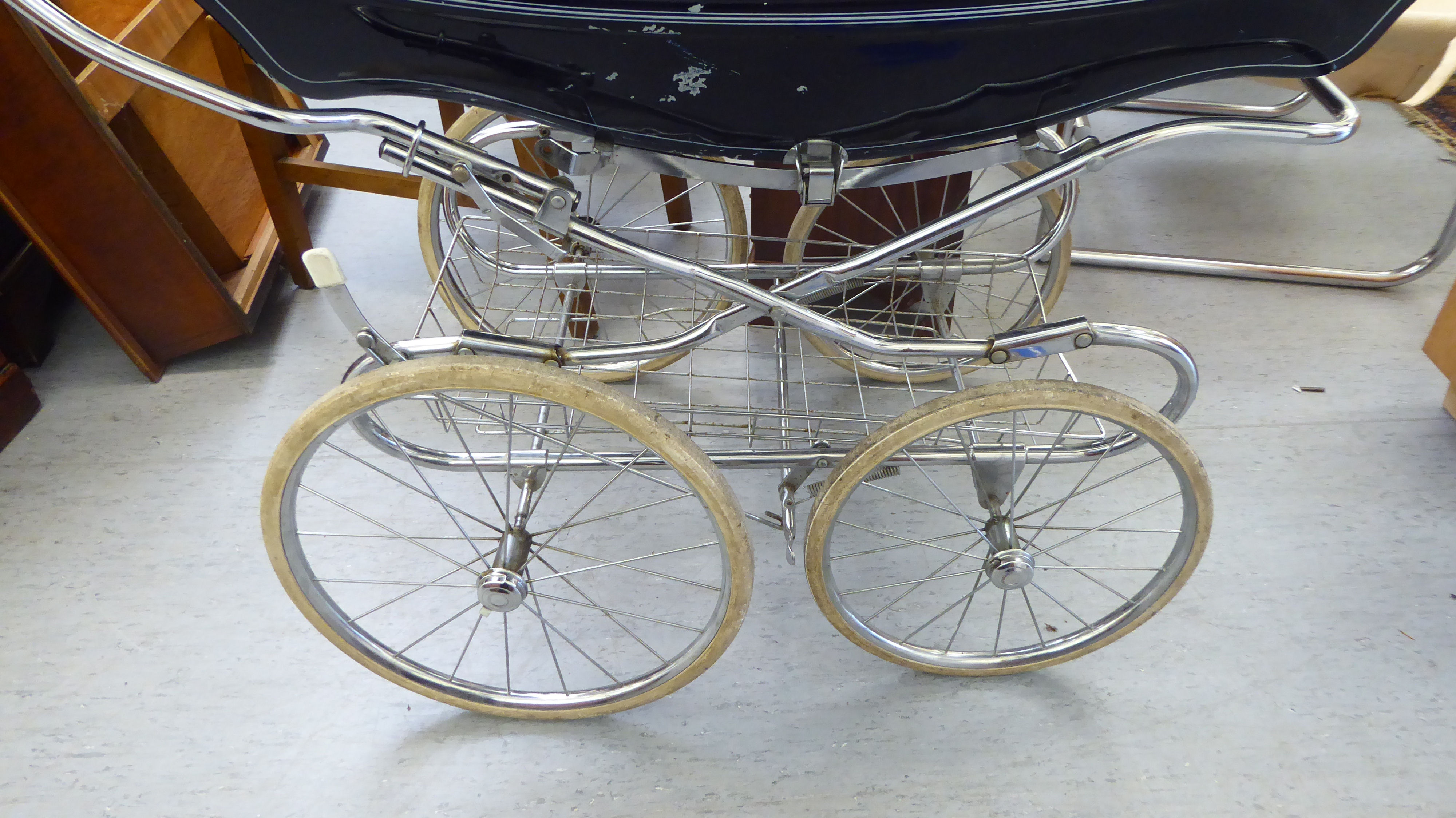 A mid/late 20thC Silver Cross coach built pram, on spoked wheels; and two celluloid dolls with - Image 2 of 4