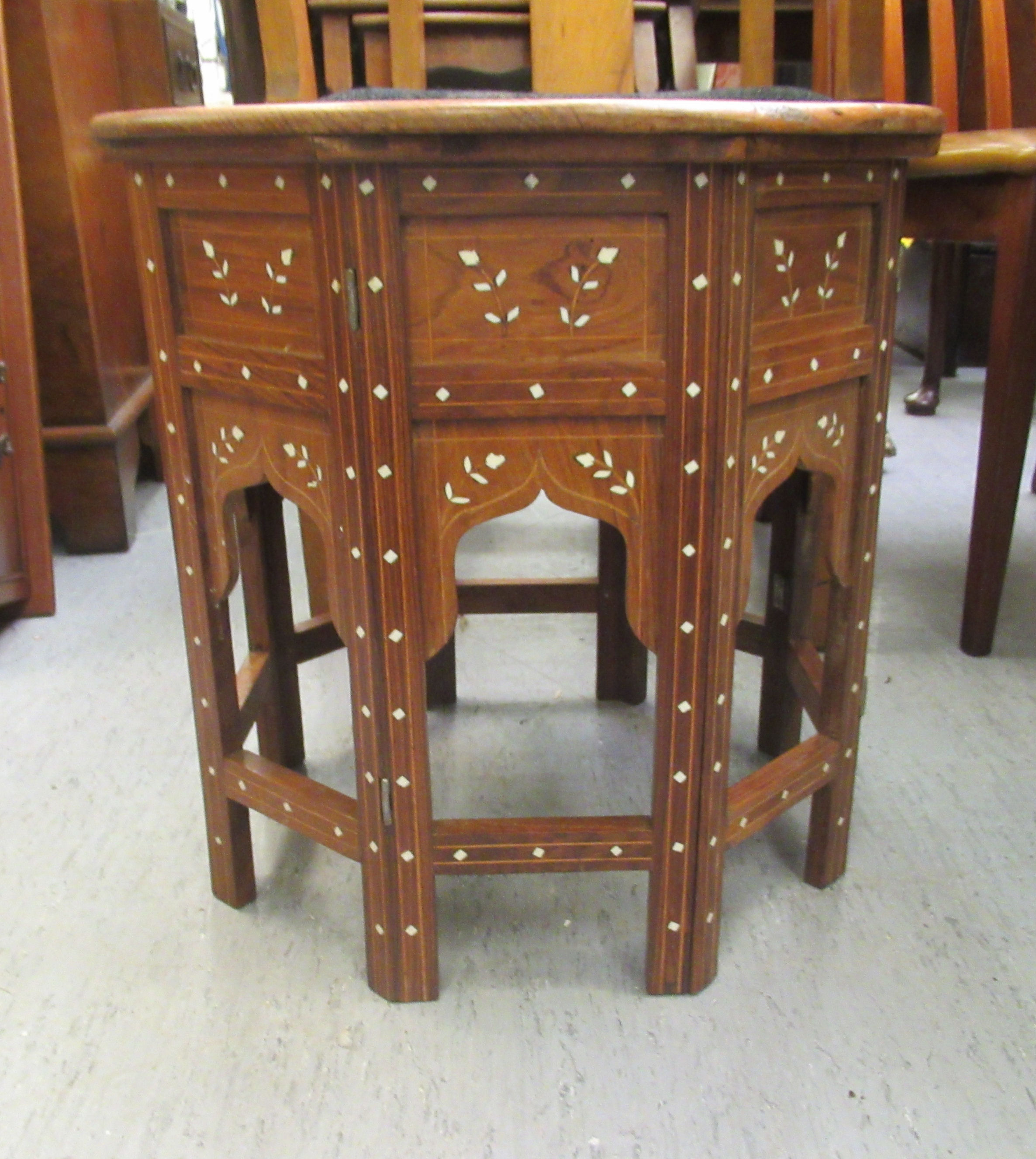 A 20thC Indian bone inlaid fruitwood occasional table, decorated with floral designs  18"h  18"dia