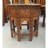 A 20thC Indian bone inlaid fruitwood occasional table, decorated with floral designs  18"h  18"dia