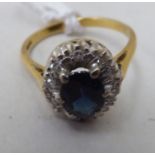 An 18ct gold sapphire and diamond cluster ring