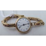 A ladies Burren 9ct gold bracelet wristwatch, faced by a white enamel Arabic dial