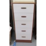 A 1960s teak finished white painted five drawer tallboy, on a plinth  42"h  17.5"w