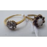 A 9ct gold garnet and opal cluster ring; and a yellow metal diamond cluster ring