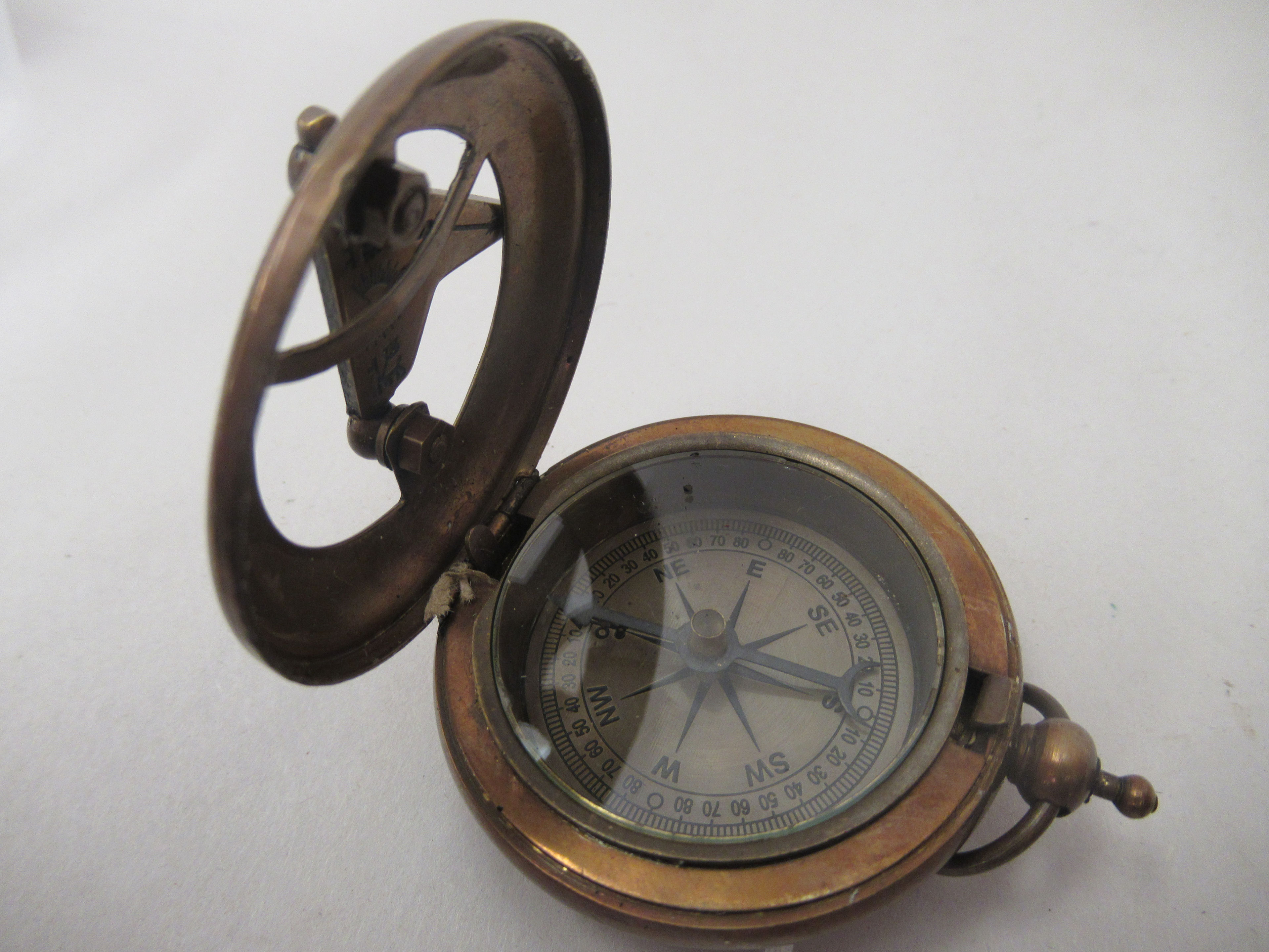 A lacquered and brass engraved brass cased pocket sundial/compass - Image 3 of 3