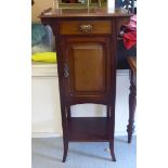 An Edwardian mahogany washstand with a single drawer and cupboard door, raised on square, tapered,