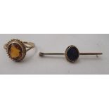 A 9ct gold scarf pin, set with a black opal; and a 9ct gold ring, set with an amber coloured stone