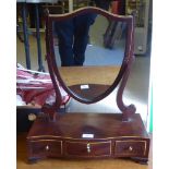 A Regency satinwood inlaid mahogany toilet mirror, having a shield shaped plate, pivoting on