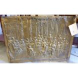 A late 19thC pressed brass plaque, featuring an interior scene with personalities including
