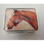 A silver coloured metal rectangular patch box, the hinged lid featuring an enamelled horses head