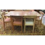 A McIntosh Furniture teak dining table, the top with rounded edges, raised on tapered legs with an