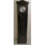 An early/mid 20thC oak cased granddaughter clock, the chiming movement faced by a brushed steel