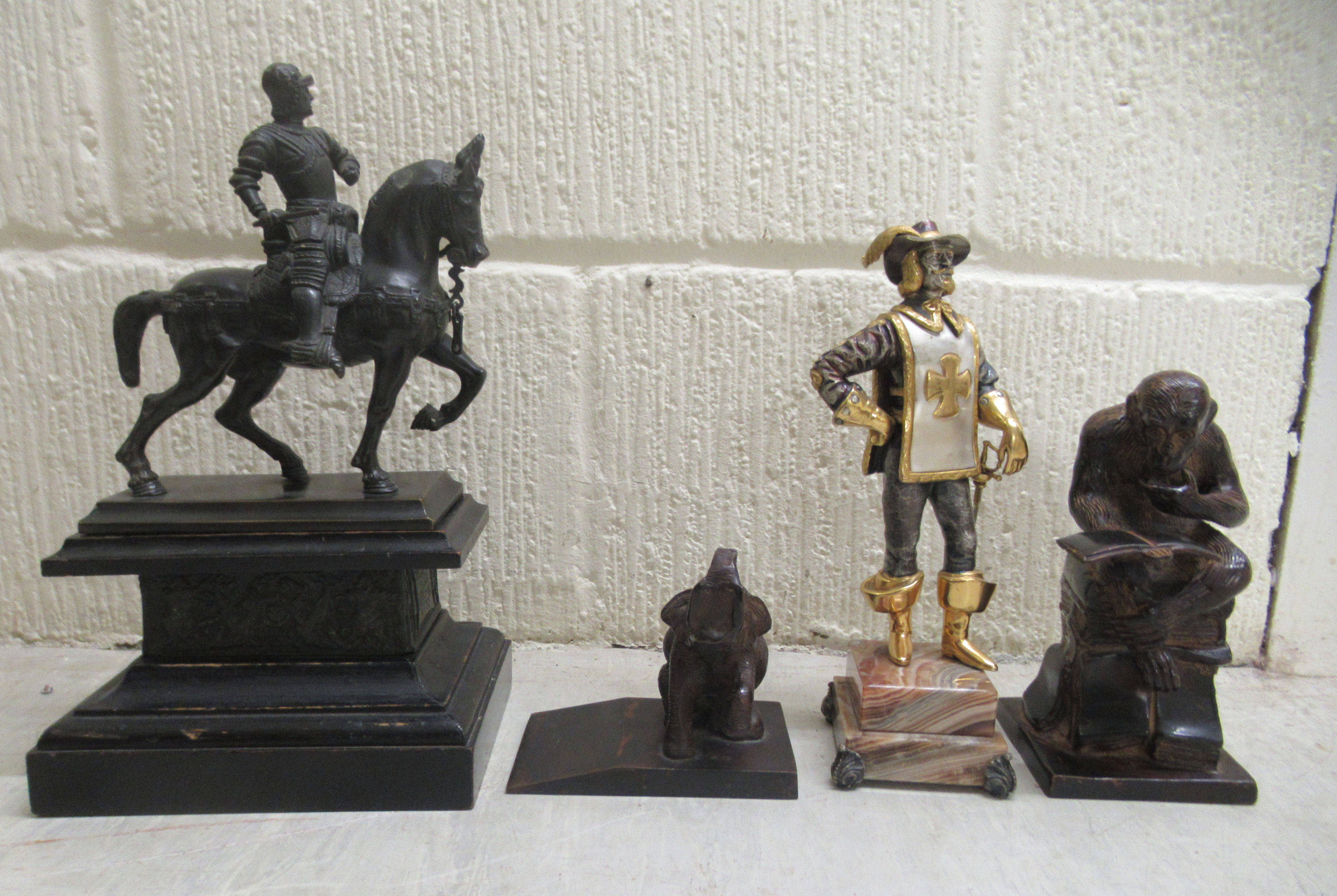 Four cast bronze figures, viz. a standing silvered and part gilded Spanish solider, on a plinth