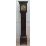 A 1930s oak cased granddaughter clock; the movement faced by a brass Roman dial  67"h