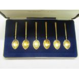 A cased set of six silver gilt teaspoons with floral decorated enamel backed bowls  Birmingham
