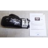A left hand Everlast boxing glove, signed 'The Baddest Man on the Planet... Mike Tyson' with a