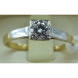 An 18ct bi-coloured gold diamond solitaire ring