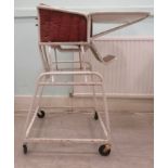 A 'vintage' white painted metal metamorphic nursery highchair, on 'big-wheel' castors