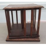 A reproduction of an Edwardian oak tabletop, revolving bookcase. on a plinth  11"h  11"sq