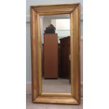 An early 20thC mirror, the plate set in a moulded gilt frame  14" x 35"