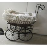 A wrought metal and woven cane dolls pram; and an Alberon doll with porcelain head and painted