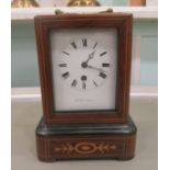 An Edwardian string inlaid rosewood mantle timepiece, on a plinth; the Henry Marc of Paris