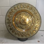 A late 19thC Persian brass charger, cast embossed and engraved with vignette studies, allegorical