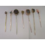 Seven variously set gold/yellow metal stickpins