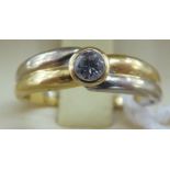 An 18ct bi-coloured gold single stone diamond ring