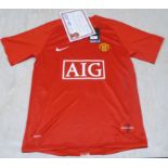 A framed Nike Manchester Utd home football shirt, signed on the obverse by no.18 Paul Scholes with a
