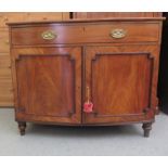 An early 19thC mahogany bow front side cabinet with a single drawer and two panelled doors, raised