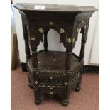 An early 20thC North African profusely carved and bone inlaid, hexagonal, two tier occasional table,