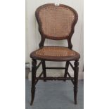 A child's late Victorian stained beech chair with a woven split cane back and seat, raised on