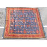 A Persian carpet decorated with repeating stylised designs on a multi-coloured ground  124" x 168"