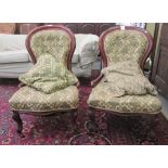 A pair of late Victorian mahogany framed spoonback salon chairs, each with a green and gold coloured