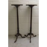 A pair of 19thC style mahogany torchers with thumb moulded piecrust edged tops, raised on fluted